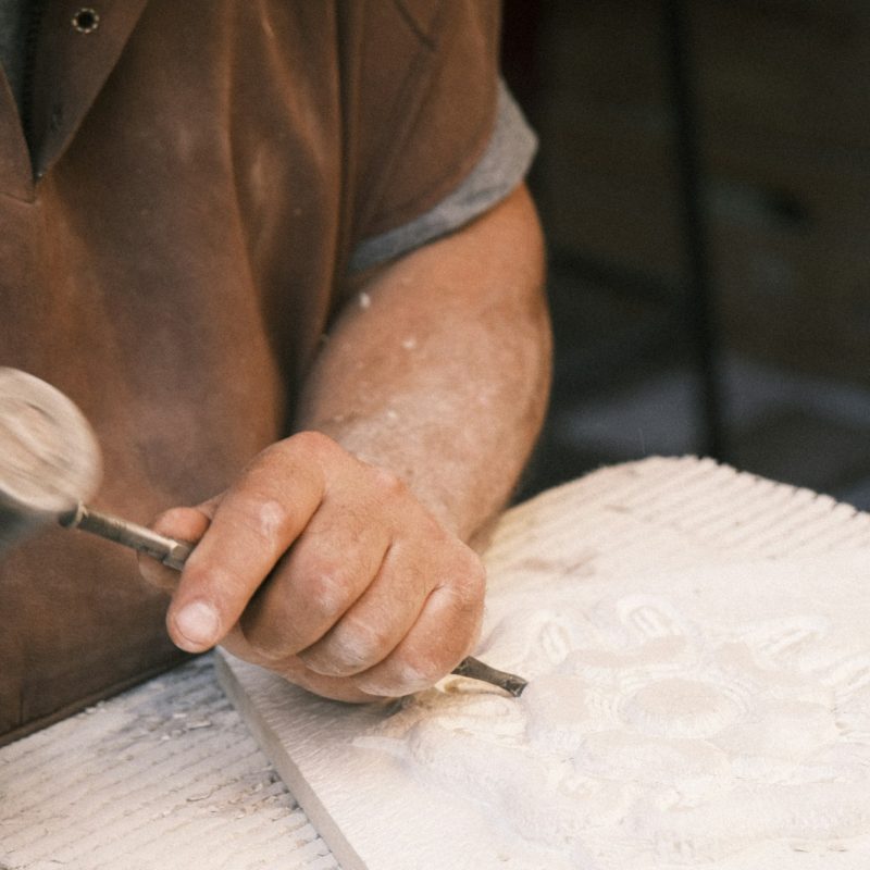 Stone carver shaping a piece of stone